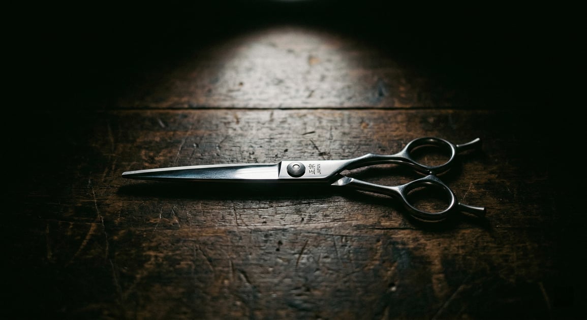 Professional hair cutting scissors on dark wood - how to tell if your scissors are sharp enough