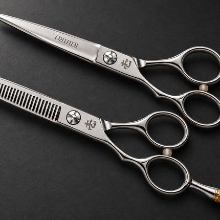 Ichiro Crown Lefty scissor set on a dark charcoal surface with gold-tone crown tangs